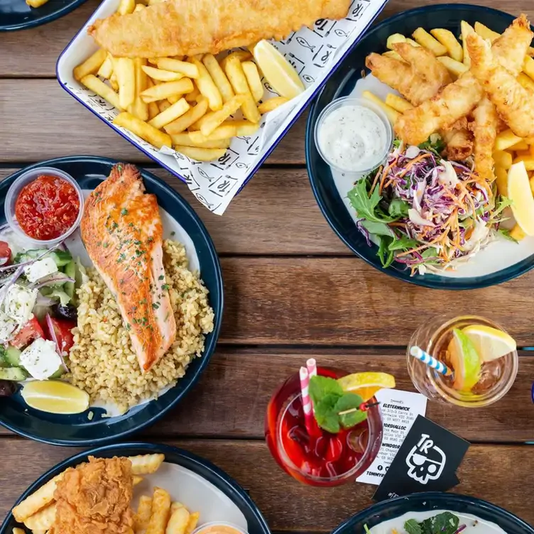 A spread of fish dishes, featuring fish and chips and salmon, at Tommy Ruff Fishbar, a restaurant in Melbourne