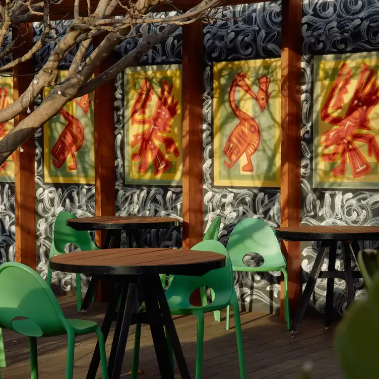 A sunny courtyard with art displayed at Jardin Tan, a restaurants in Melbourne