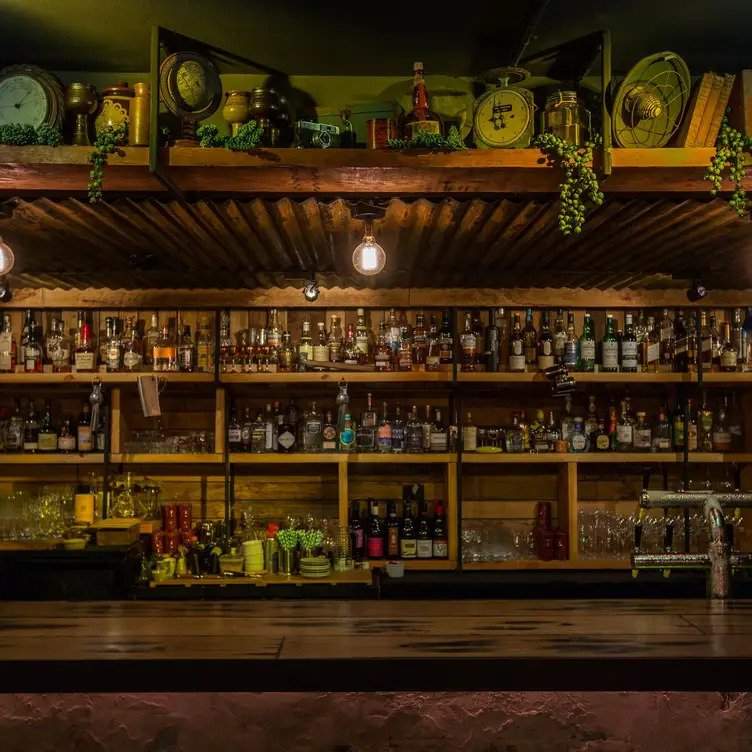 Bottles lined up on the walls at Door Knock, one of the best bars in Sydney CBD