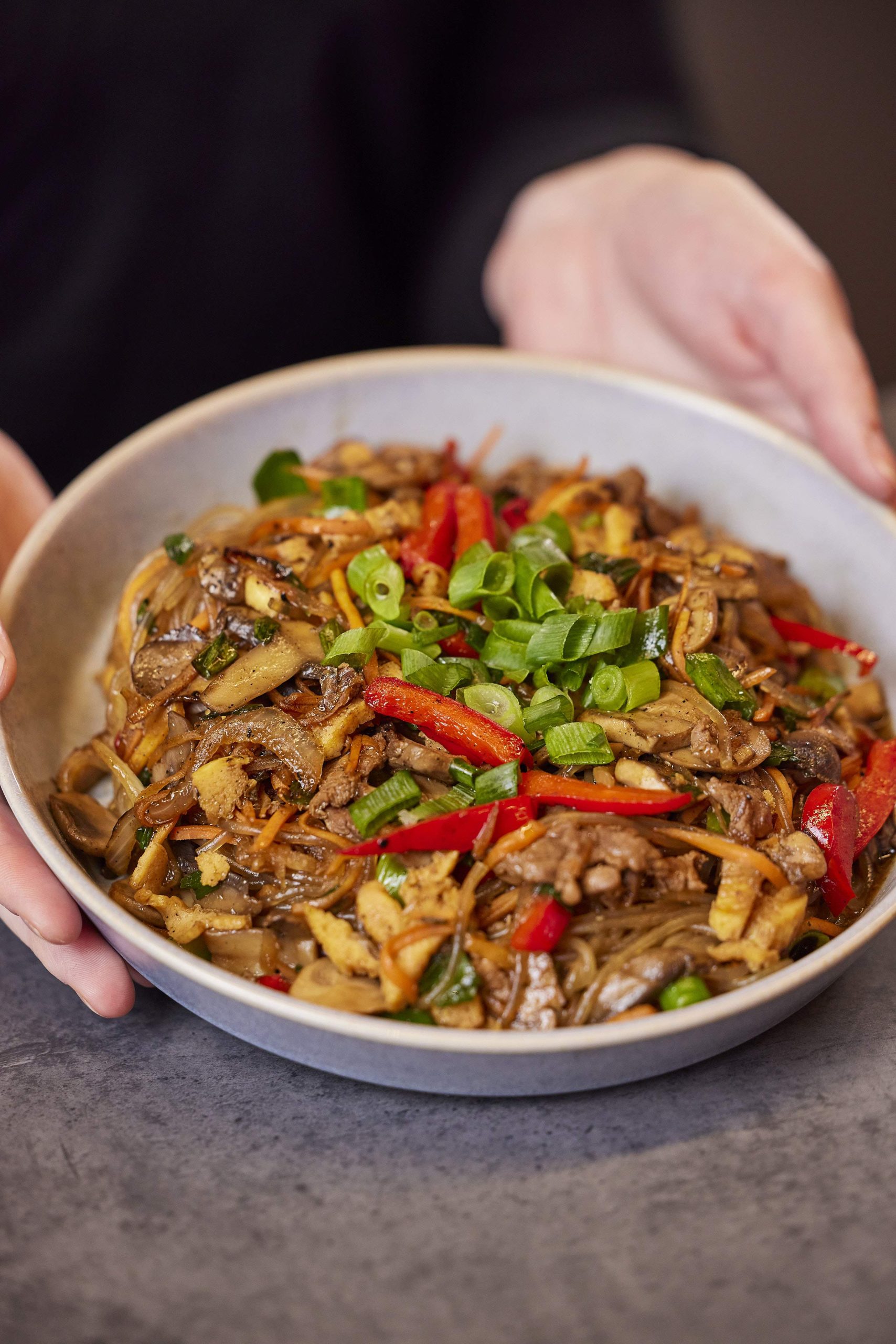 Sauteed chicken and bulgogi beef japchae dish at Bonchon, a restaurant in Melbourne.