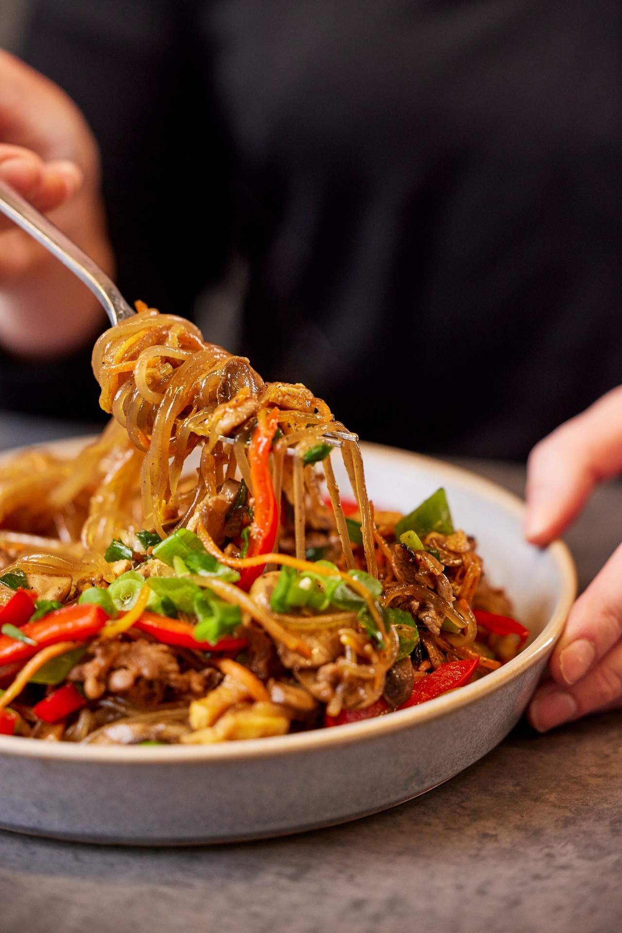 Sauteed chicken and bulgogi beef japchae dish at Bonchon, a restaurant in Melbourne.