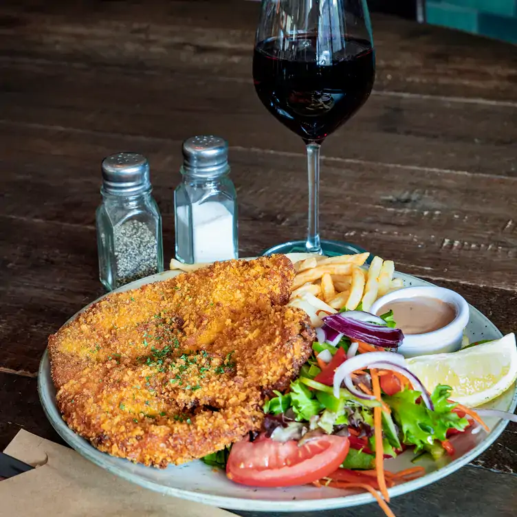 A chicken schnitzel with a glass of red wine at The Lord Raglan Hotel, one of the best pubs in Sydney