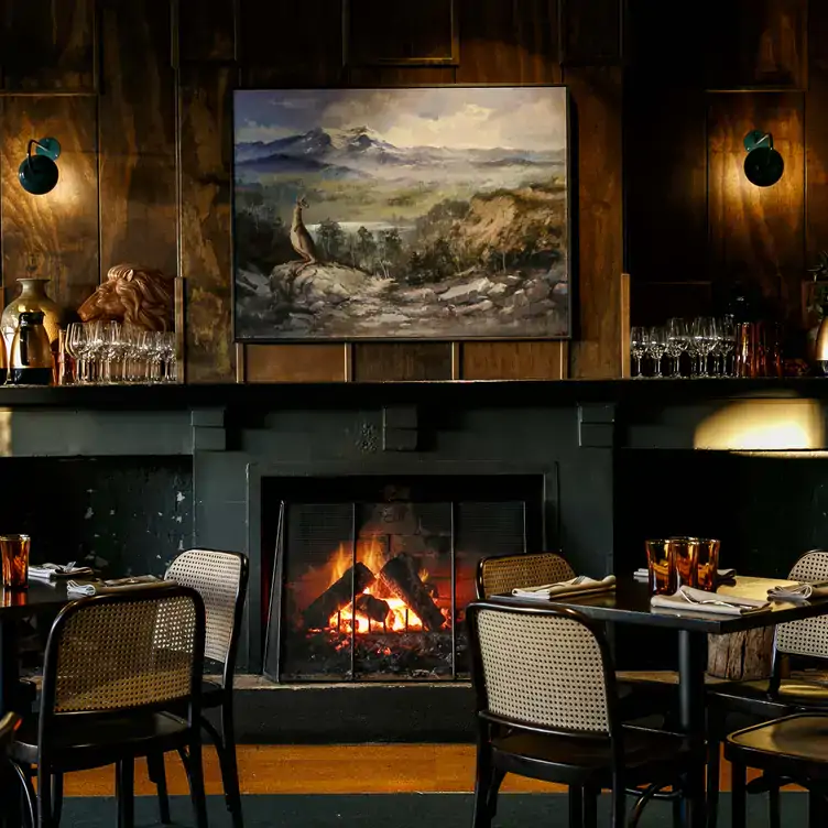 Restaurant interiors with a roaring fireplace at Mount Erica Hotel, one of the best gastro pubs in Melbourne