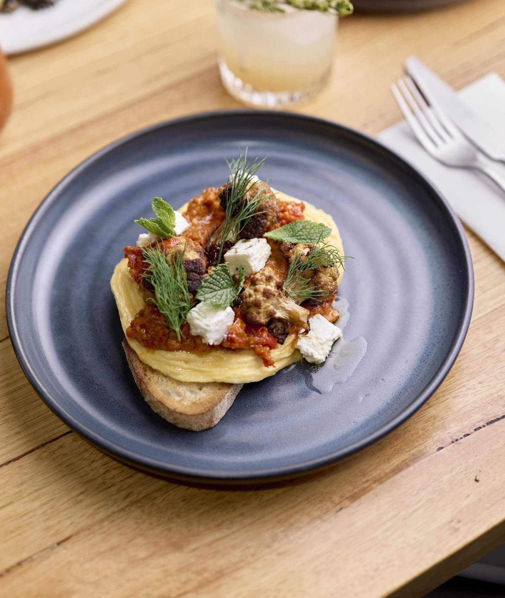 A toast topped with an omelette and vegetables at Nancy Eatery, a restaurant in Melbourne