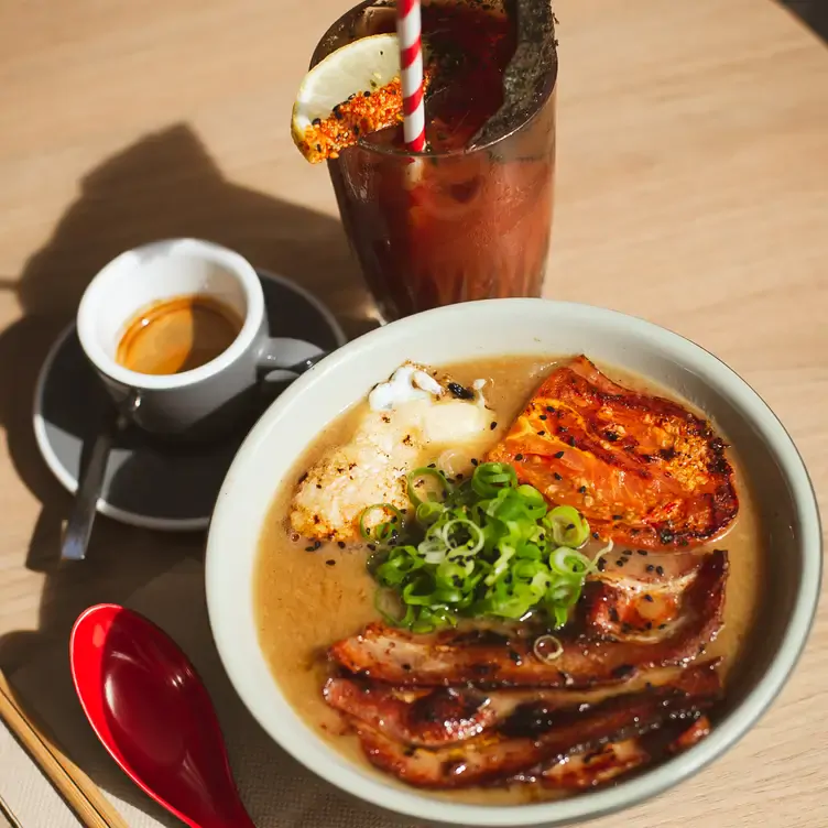 A ramen bowl sits next to a coffee and a bloody mary cocktail at Rising Sun Workshop, a restaurant in Sydney