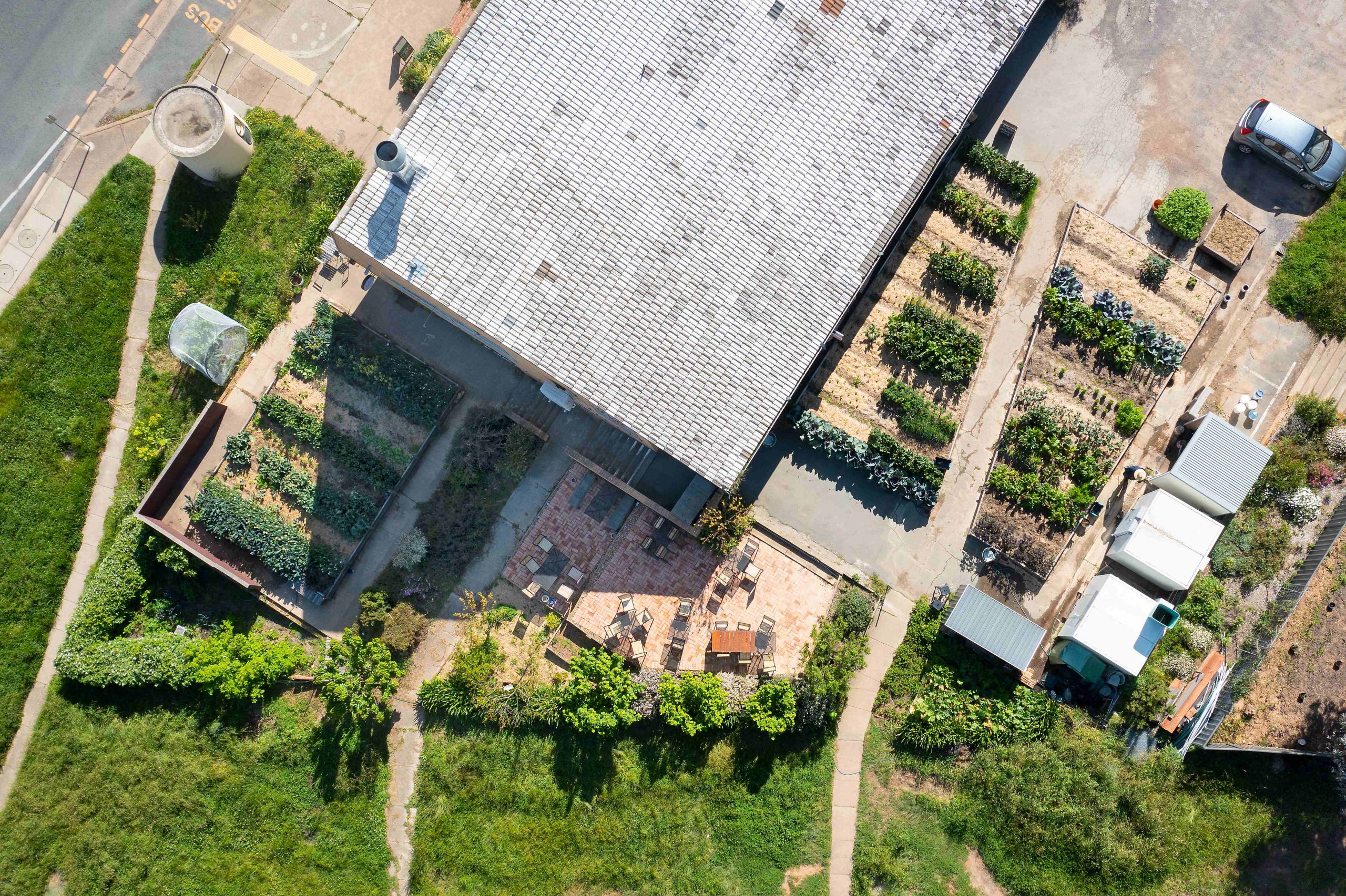 A bird’s-eye view of Canberra cafe Two Before Ten’s urban farm and large grey roof building.