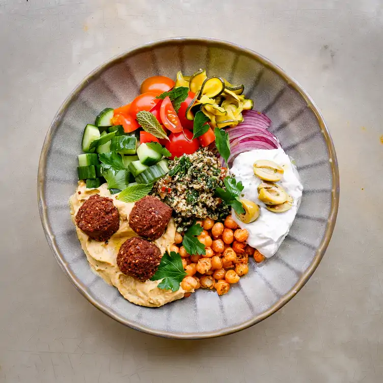 A dish with different vegetables, chickpeas, falafels and dip served at Vegie Bar, one of the best vegan restaurants in Melbourne.