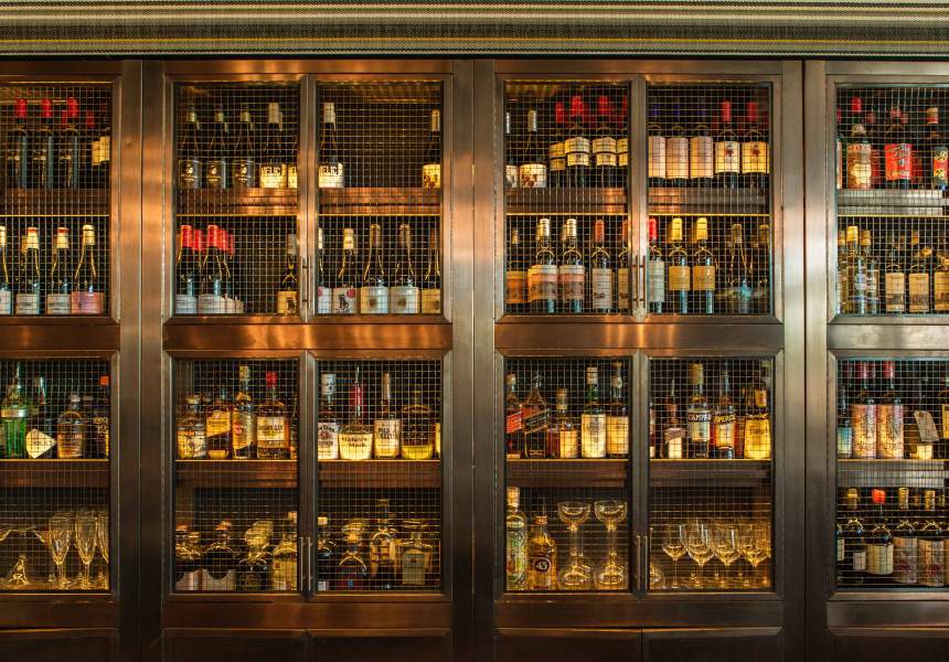 Wine cages showcasing an extensive alcohol collection at BORN by Tapavino in Barangaroo