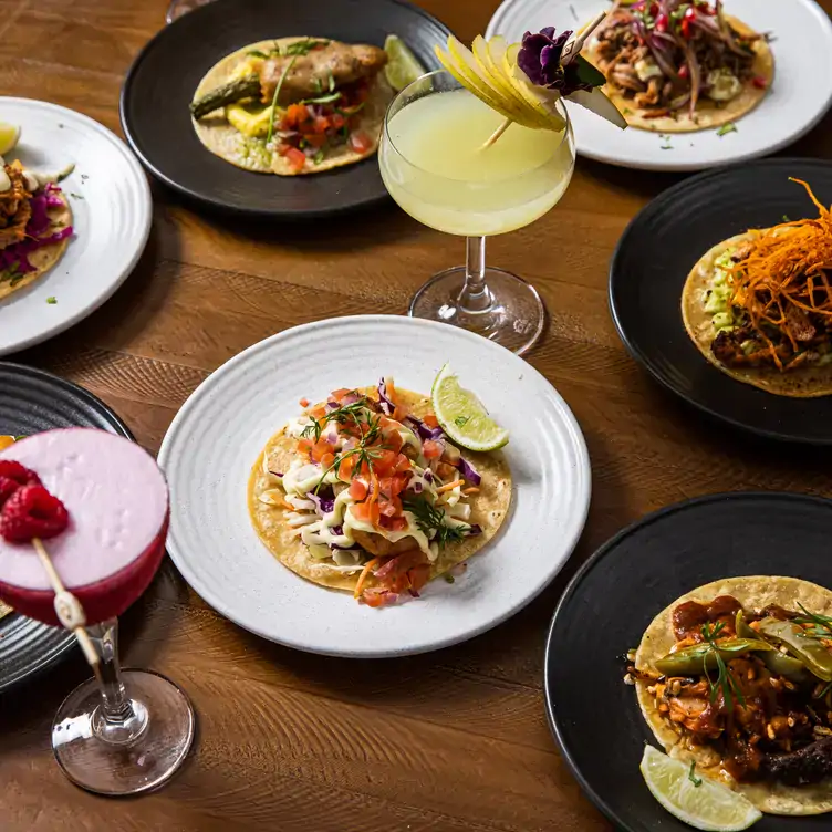 A spread of Mexican dishes featuring tacos and margaritas at Tommy's Darlinghurst, one of the best Mexican bars and restaurants in Sydney