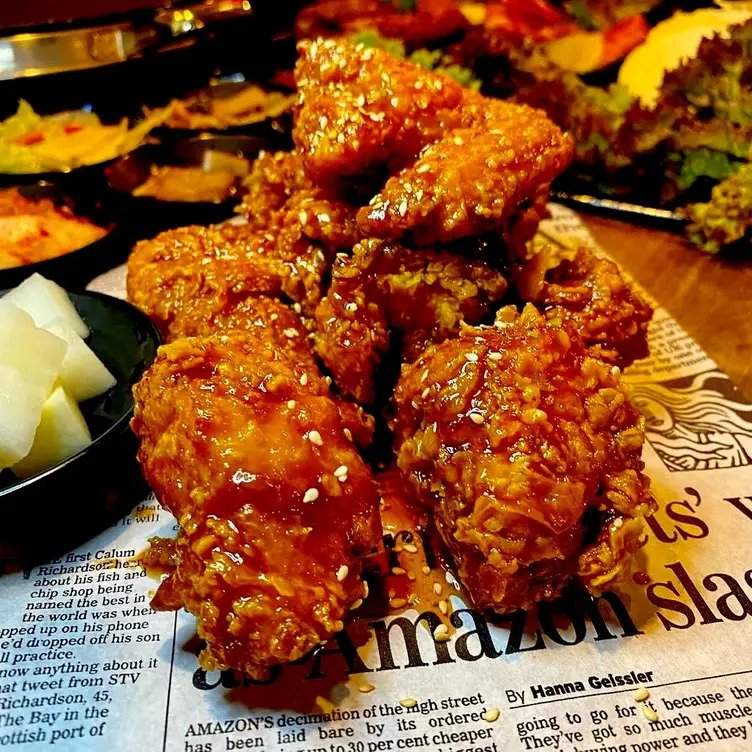 Extra spicy Korean fried chicken on top of a newspaper at K-Town BBQ House - one of the best Korean restaurants in Sydney