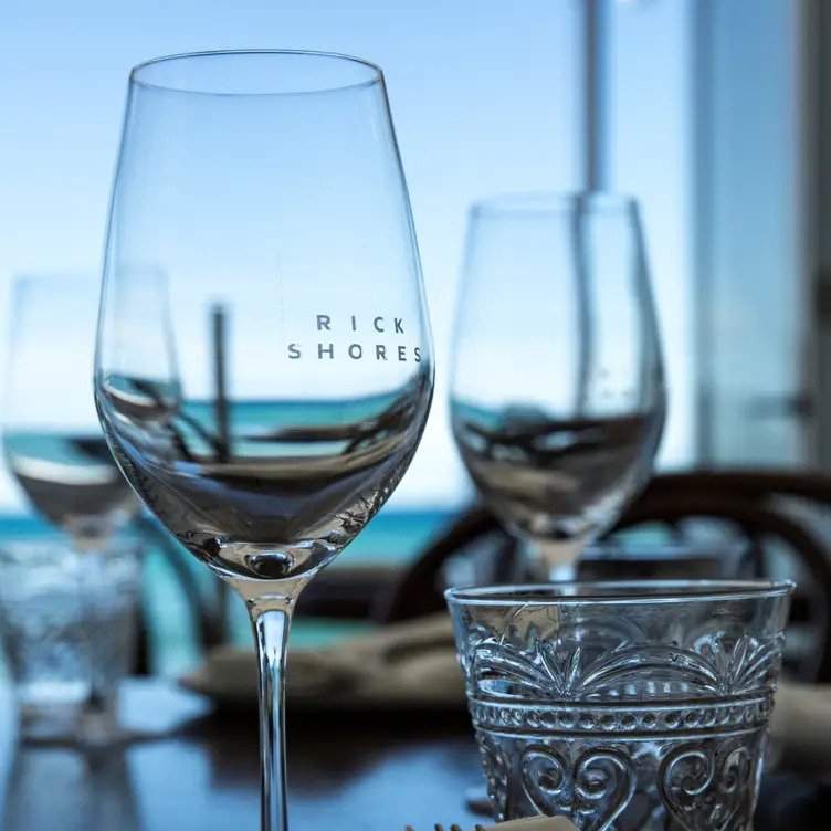 Wine glasses and an ocean view at Rick Shores in Brisbane, one of the best restaurants in Australia