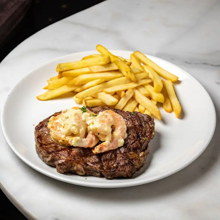 Char-grilled steak with prawns and chips from The Clare Castle – one of the best steak restaurants in Melbourne. Credit: The Clare Castle