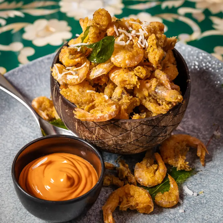 A prawn dish with sauce on the side served at The Grand Palace, one of the best Indian restaurants in Sydney.