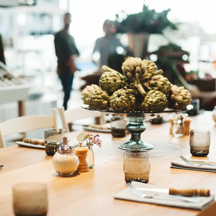 A beautifully laid table featuring a display of artichokes at Butcher and the Farmer, one of the best steak restaurants in Sydney. Credit: Butcher and the Farmer