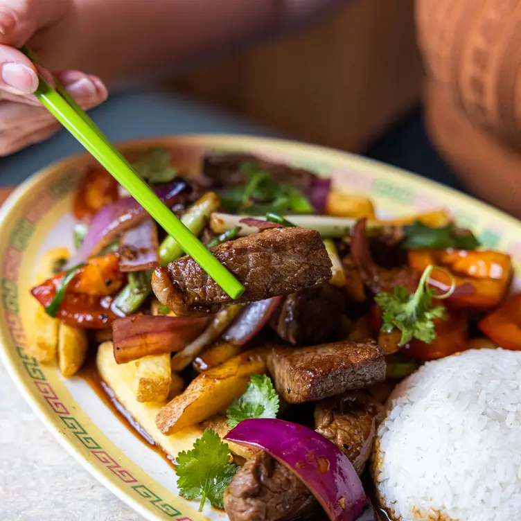 An image of Lomo Saltado, a dish with beef, chips and rice at Casa Chow, one of the best Asian restaurants in Brisbane.