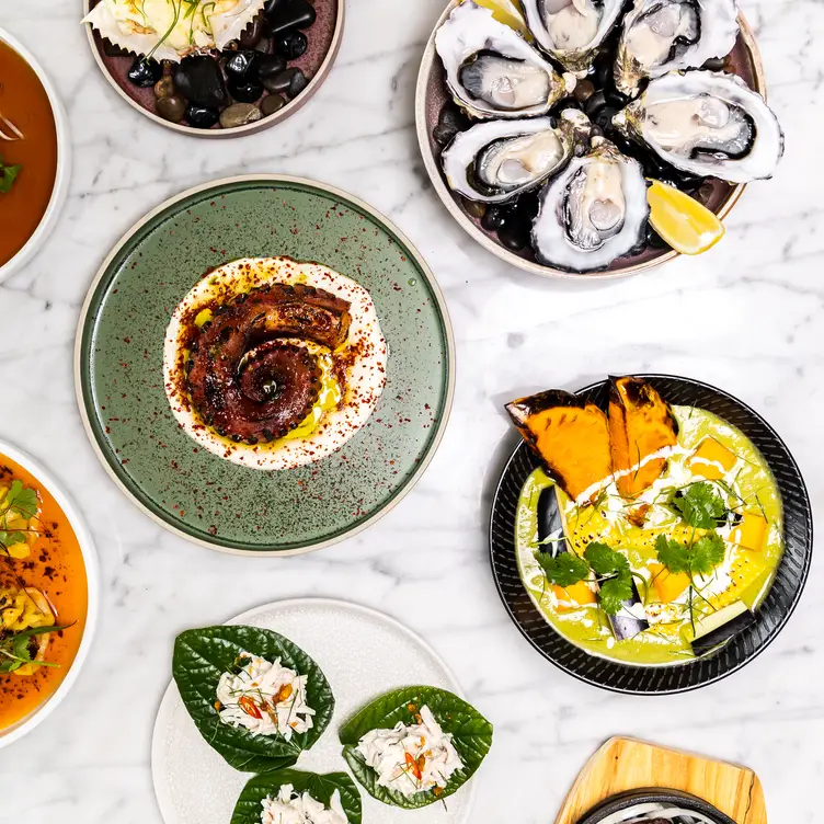 Seafood, meat and vegetable dishes on a table at Cha Ching one of the best Asian fusion restaurants in Melbourne.