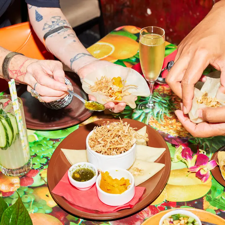 People enjoying an appetiser and drinks at Colonel Tan’s – one of the best Melbourne vegetarian restaurants.