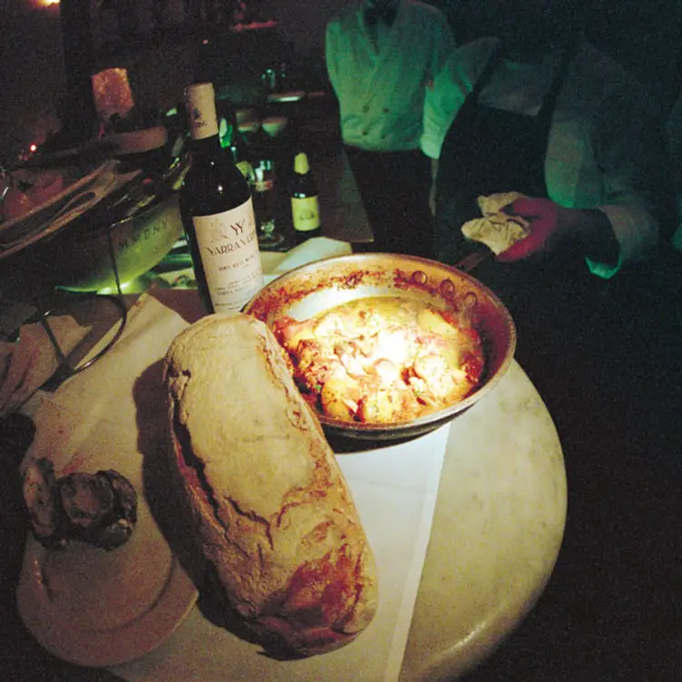 A dish accompanied by a bottle of wine at Di Stasio, one of the best Italian restaurants in Melbourne. Credit: Di Stasio