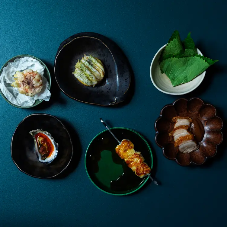 A snack flight of oyster, octopus skewer, and black tiger prawn tart with perilla at Longshore in Chippendale.