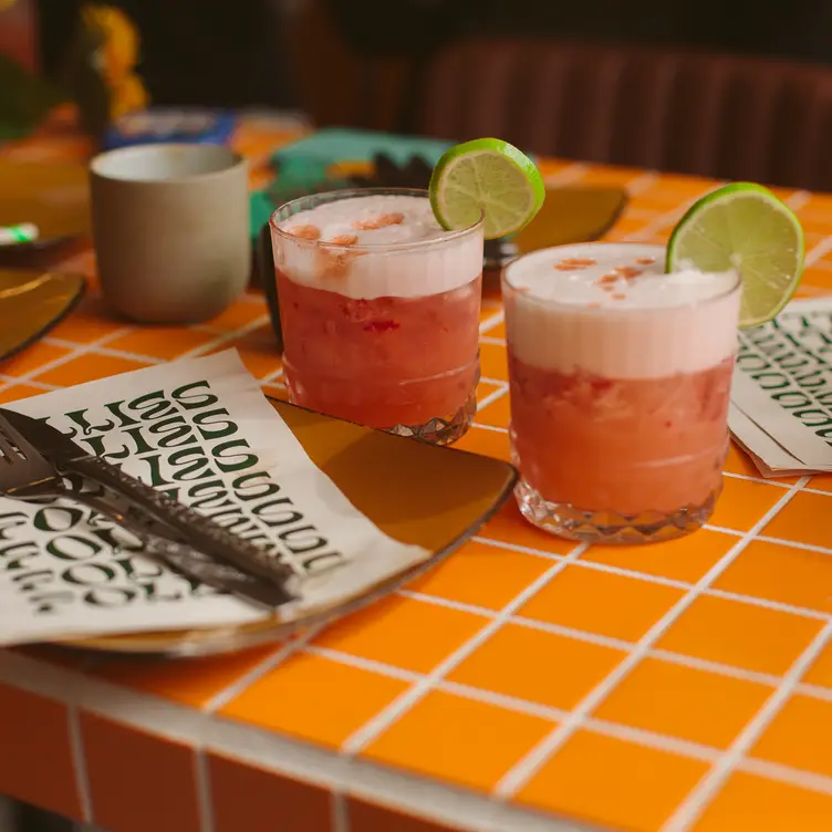 Two garnished cocktails on a table at Follies Bar – one of the best Melbourne vegetarian restaurants.