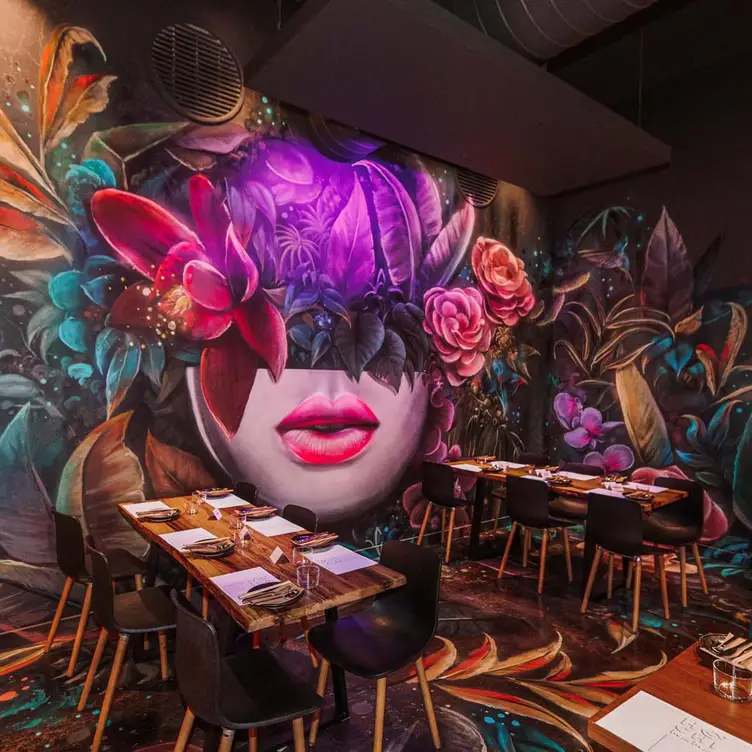 The tables and bold paintings on the walls of Hochi Mama, one of the best Asian restaurants in Melbourne.