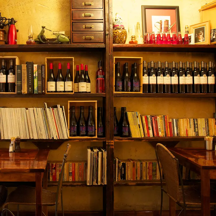 Wine bottles and books stacked on shelves at Il Solito Posto, one of the best Italian restaurants in Melbourne. Credit: Il Solito Posto