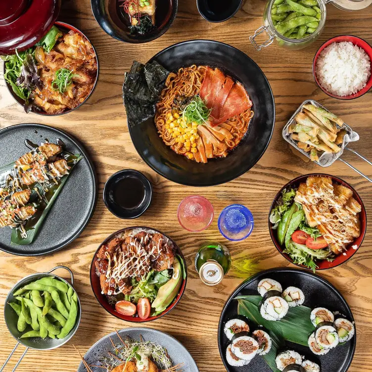 A table laid with several dishes, including ramen and sushi, from Izakaya Midori, one of the best vegan restaurants on the Gold Coast.