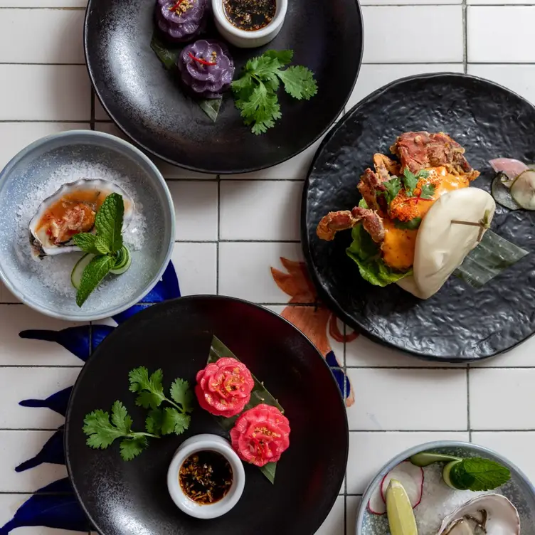 A photo of multiple dishes including Bao at Jumbo Thai Bar & Restaurant, one of the best Asian restaurants in Brisbane.