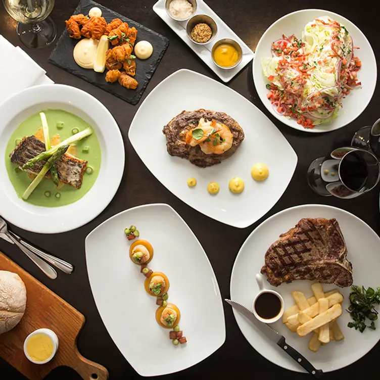 A variety of dishes spread on a table at Kingsleys Australian Steakhouse, one of the best steak restaurants in Sydney. Credit: Kingsleys Australian Steakhouse