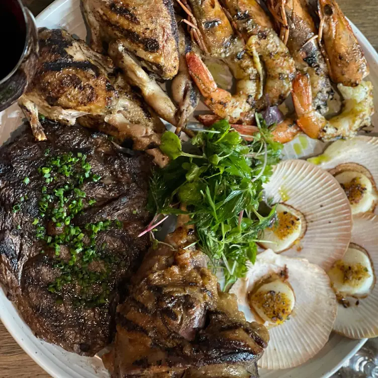 Steak and seafood on a plate at La Boucherie, one of the best steak restaurants in Sydney. Credit: La Boucherie