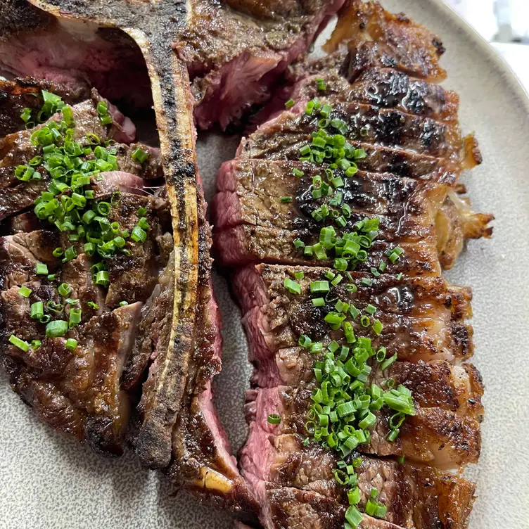 Close-up of a sliced T-bone steak at La Boucherie, one of the best steak restaurants in Sydney. Credit: La Boucherie