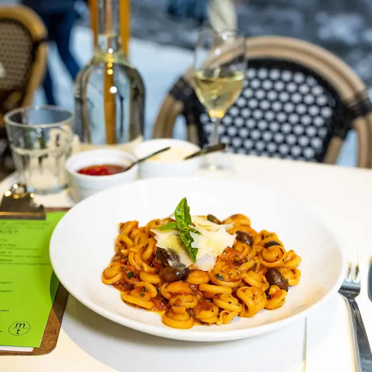 A plate of vegan pasta and a glass of wine at Maccaroni Trattoria Italiana – one of the best Melbourne vegetarian restaurants.