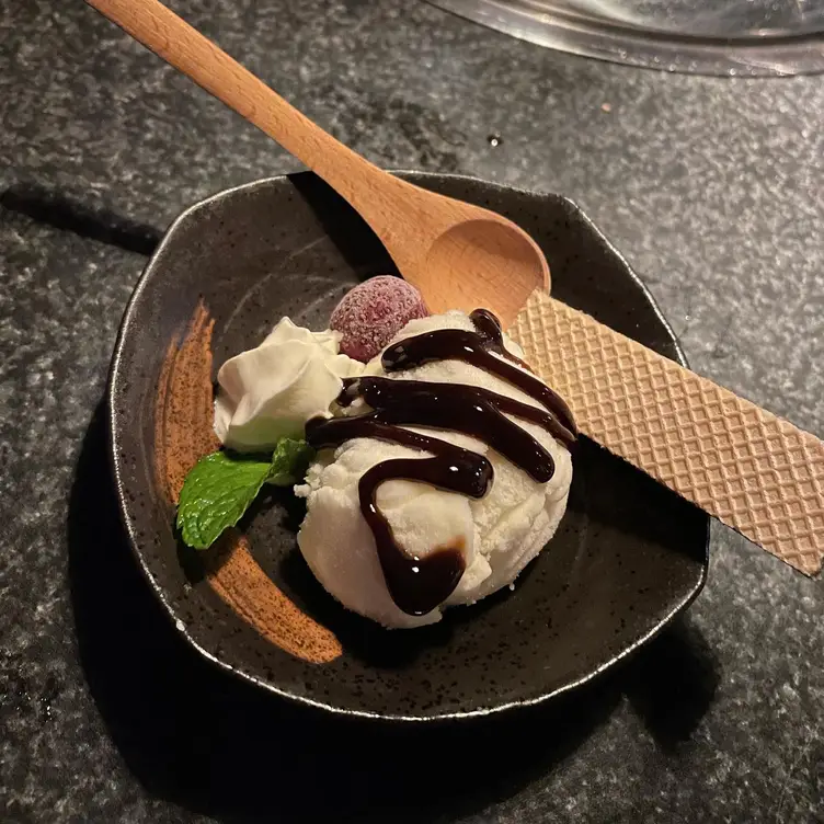 A bowl with a scoop of ice cream, a wafer, a dollop of cream and garnishes at the Nonbei Sake Bar & Grill, one of Brisbane’s best Asian restaurants.