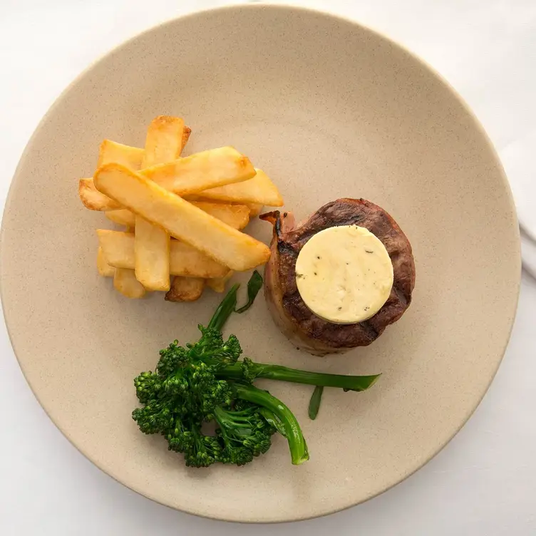 Steak, chips and garnish on a plate at Steersons Steakhouse, one of the best steak restaurants in Sydney. Credit: Steersons Steakhouse