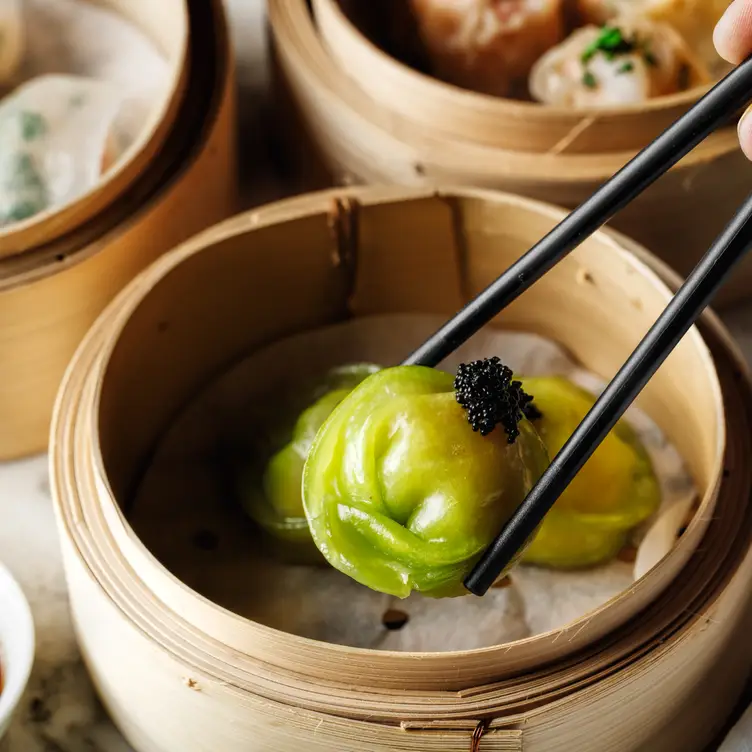 Multiple dishes are crowded on a table showcasing the range of Tai Tai, one of Brisbane’s best Chinese restaurants.