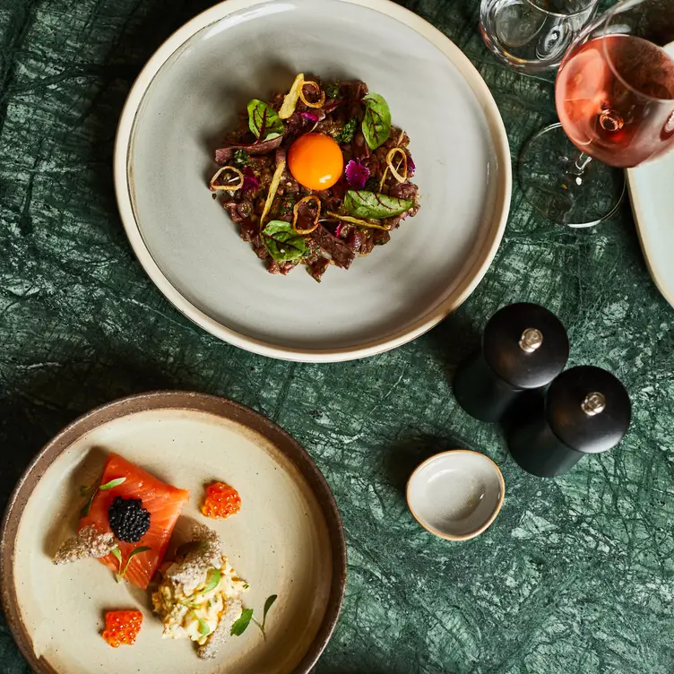 A plate of steak and a plate of fish at The Graham Hotel, one of the best steak restaurants in Melbourne. Credit: The Graham Hotel