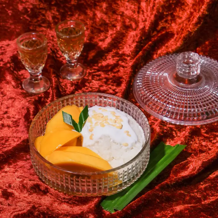 A mango and rice dessert served in a glass dish at Chat Thai.