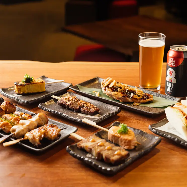 A selection of meat skewers and beer on a table at 1603 Bar, one of Brisbane’s best Japanese restaurants.