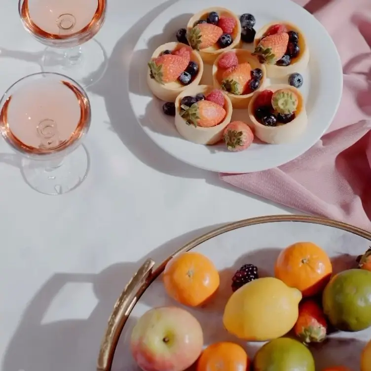 Fruit, desserts and drinks on a table at Danté, one of the best Greek restaurants in Melbourne.