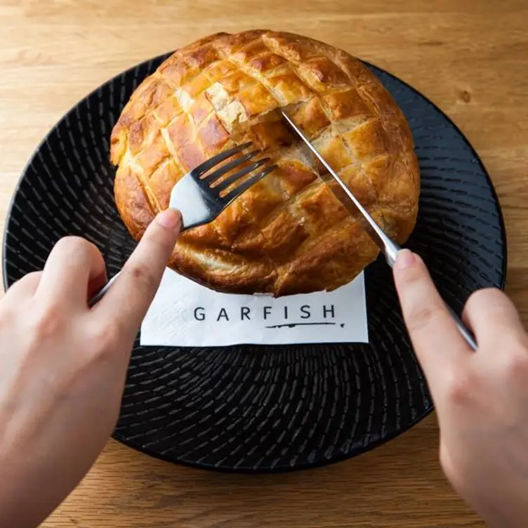 POV of cutting into the snapper pie at Garfish Crows Nest – awarded the best seafood restaurant in Sydney.