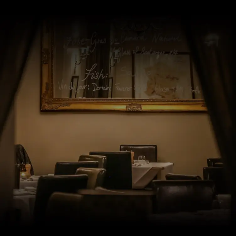 A sepia-toned picture of the dining area at Le Petit Bistro, one of Melbourne’s best French restaurants.