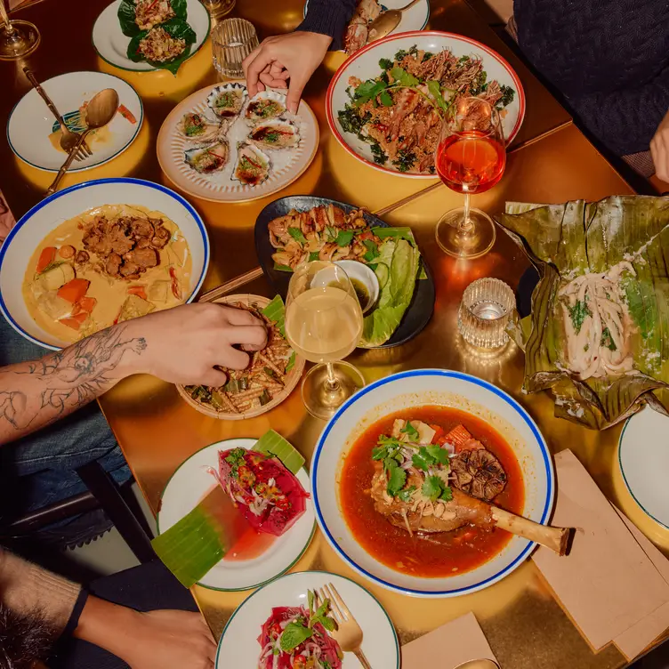 A table packed with various dishes at Thai Tide - Melbourne CBD, one of the best Thai restaurants in Melbourne.