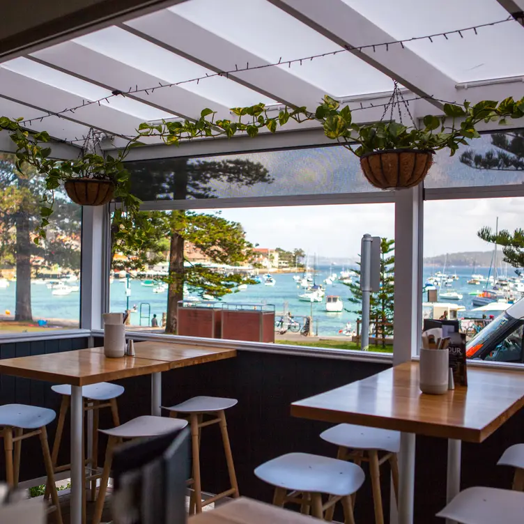 View of Sydney Harbour from the dining area at Garfish Manly, one of the best seafood restaurants in Sydney.