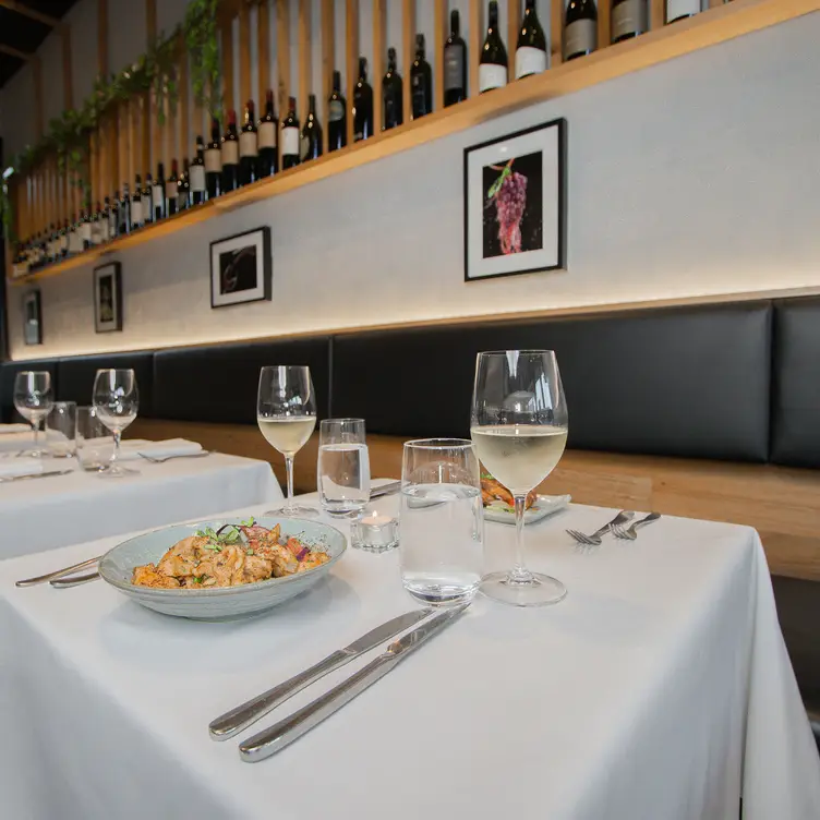 Interior shot of the dining area with wine and a French meal served at La Majestic in Prahran, Melbourne.