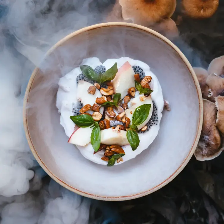 A dessert with fruit, chia seeds and coconut displayed at Detour, one of the best casual date restaurants in Brisbane.