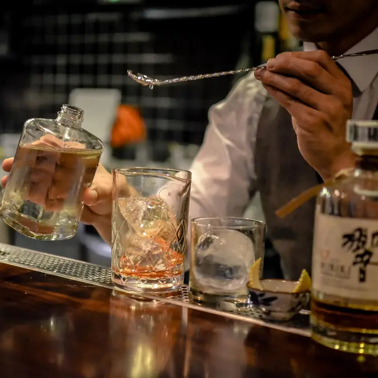 A bartender mixing drinks at Tokyo Bird, one of Sydney’s best Japanese restaurants.