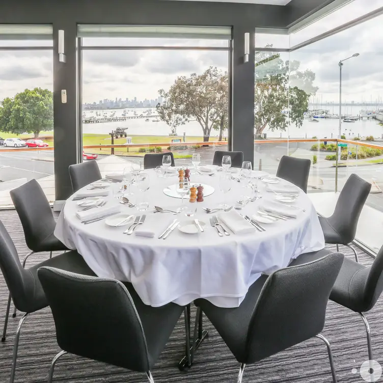 A round table and glass windows inside The Strand.