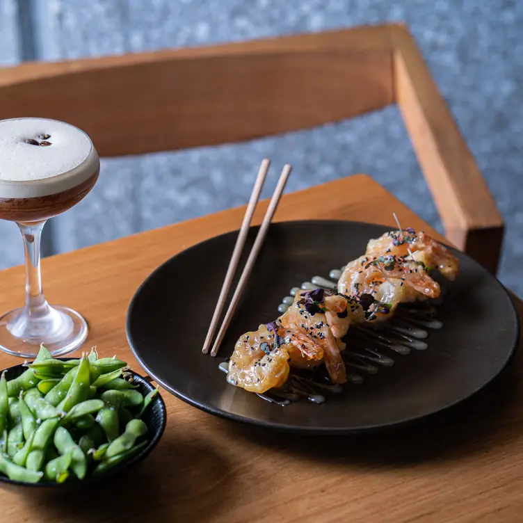 A seafood dish served alongside edamame and an espresso martini at Zushi, one of the best Japanese restaurants in Sydney.