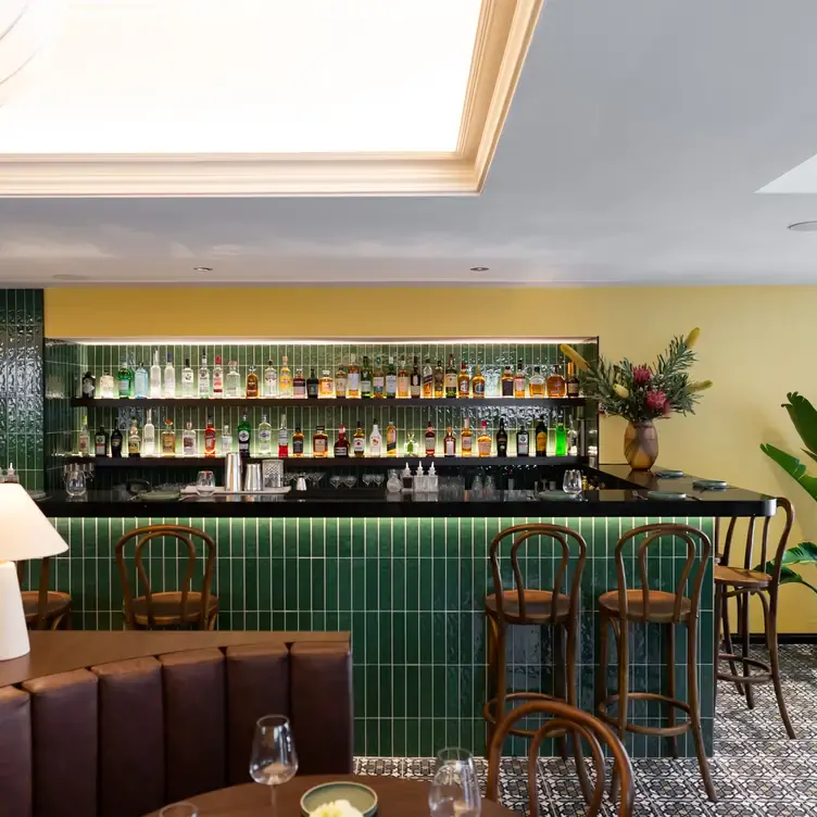 The green tiled bar, lined with wooden chairs at Hoiana, one of Melbourne’s best new restaurants.