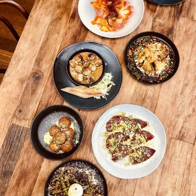 Several dishes including arancini balls and salad, served at Phillip Island Winery, one of the best wineries in Victoria.